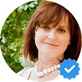 Portrait of Karen Davis, a 50-year-old woman from Burnaby, smiling with a verified checkmark, representing a satisfied Hellamaid customer.